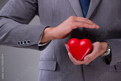 Businessman holding red heart in love concept © Elnur