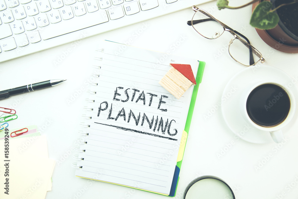 Estate Planning text on notepad and house model Estate Planning text on notepad and house model