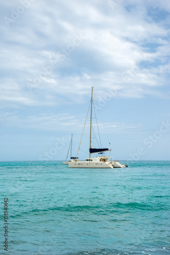 White sailing catamarans in a turquoise sea