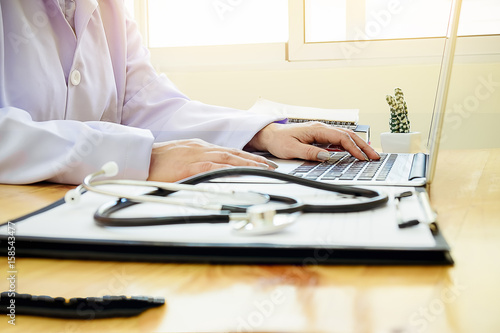 medicine doctor  working in hospital or pharmacist sitting at worktable  writing prescription on special form.Medical care and medical Stethoscope with clipboard pharmacy or insurance concept.