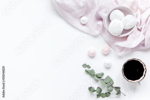light breakfast with marsh-mallow and coffee on white table background top view space for text