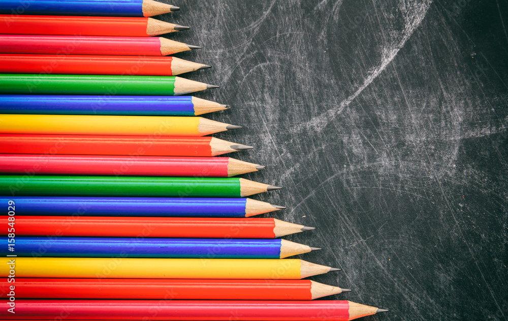 Colored pencils on a black board Colored pencils on a black board
