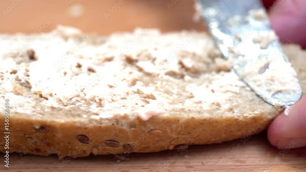 KNIFE SPREADING PATE ON A SLICE OF BREAD. SPICY INGREDIENTS AROUND ON THE TABLE. EXTREME CLOSE UP DOLLY SHOT, CAMERA SLIDING WITH KNIFE, LEFT TO RIGHT KNIFE SPREADING PATE ON A SLICE OF BREAD. SPICY INGREDIENTS AROUND ON THE TABLE. EXTREME CLOSE UP DOLLY SHOT, CAMERA SLIDING WITH KNIFE, LEFT TO RIGHT