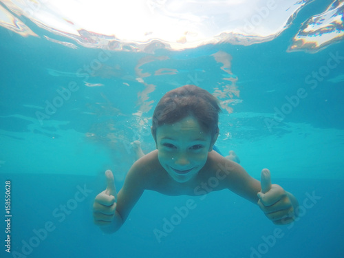 Little boy swimming underwa...