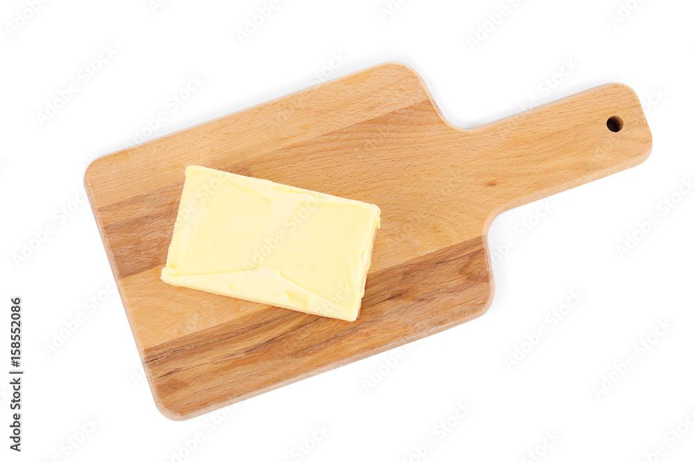 Wooden board with butter on white background