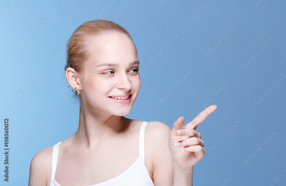 Beauty Spa Woman with perfect face skin Portrait. Girl showing empty copy space. Proposing a product. Gesture for advertisement. Beauty Spa Woman with perfect face skin Portrait. Girl showing empty copy space. Proposing a product. Gesture for advertisement.