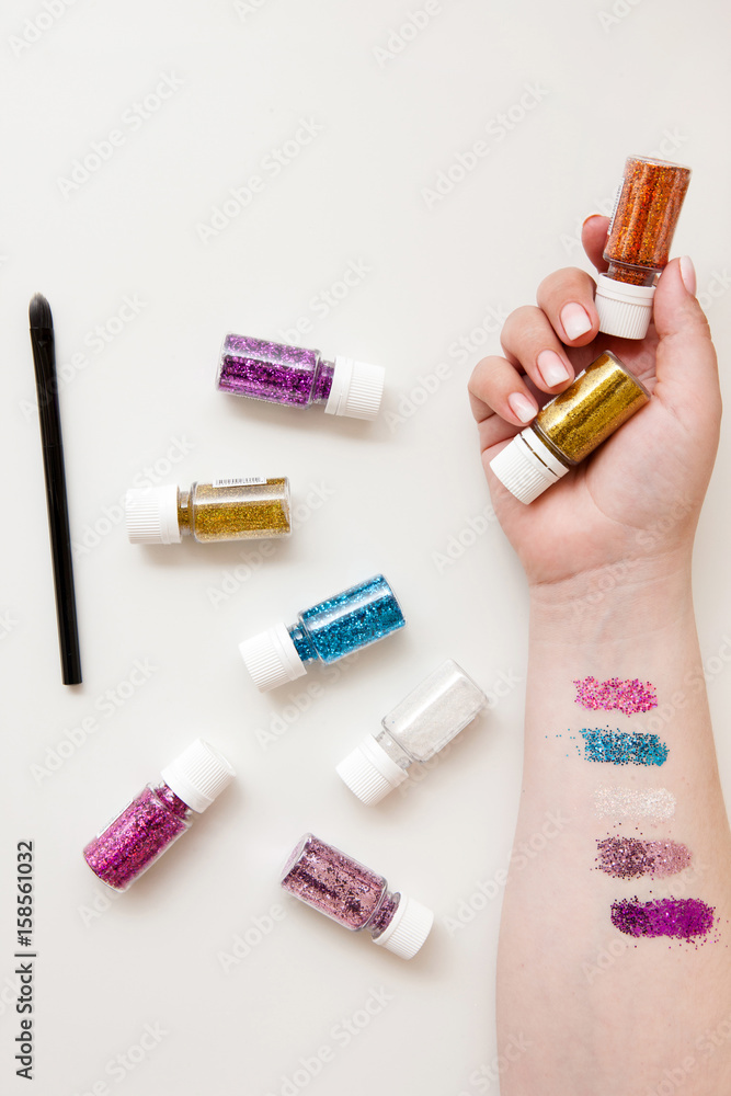 Sparkle glitter swatch on hand. Makeup addiction, unicorn trend, glamour eyeshadow concept Sparkle glitter swatch on hand. Makeup addiction, unicorn trend, glamour eyeshadow concept