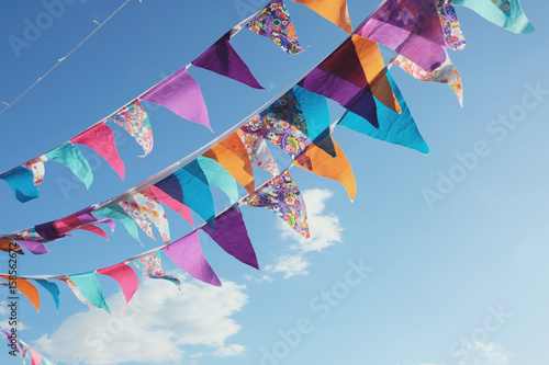 Summer festive colorful bunting and blue sky, summer event celebration photo