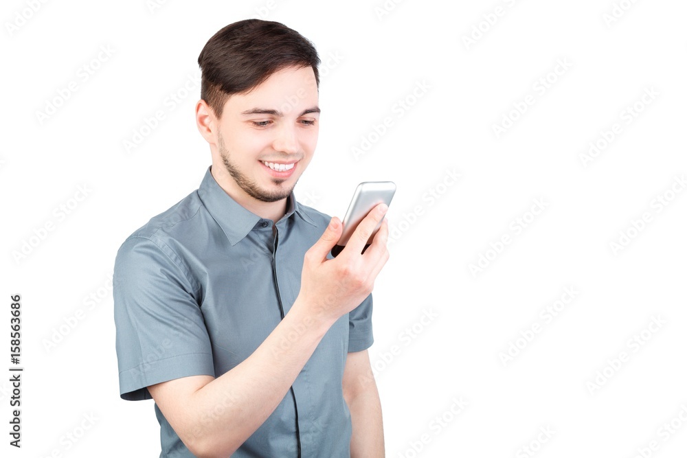 young man answering smartphone over white background. A man is talking on the phone young man answering smartphone over white background. A man is talking on the phone