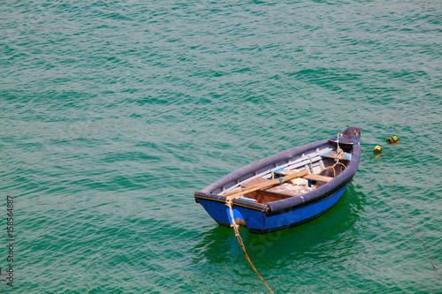 Boat on calm sea  in Cascais Bay, Cascais, Portugal © Kalnenko