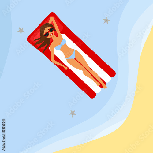 The girl is sunbathing on an air mattress