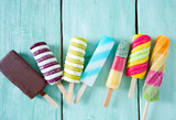 colorful popsicle ice cream on turquoise wooden background