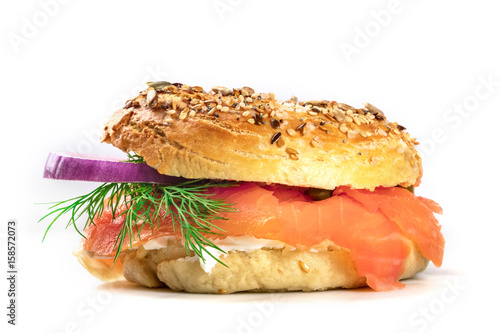 Foto Sesame bagel with cream cheese and lox, on white