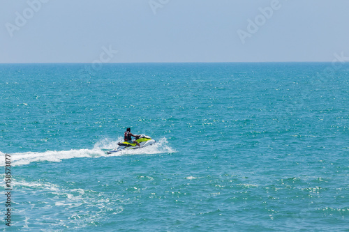 Man riding a water scooter at sea