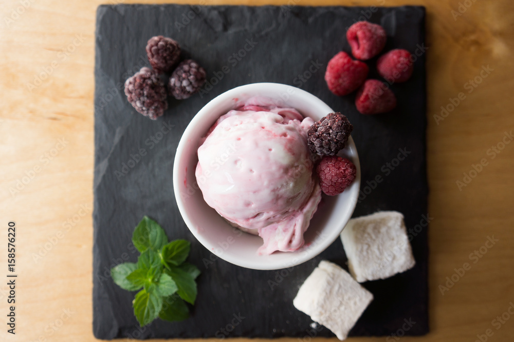 The ice cream with berries marshmallow and mint on the slate The ice cream with berries marshmallow and mint on the slate