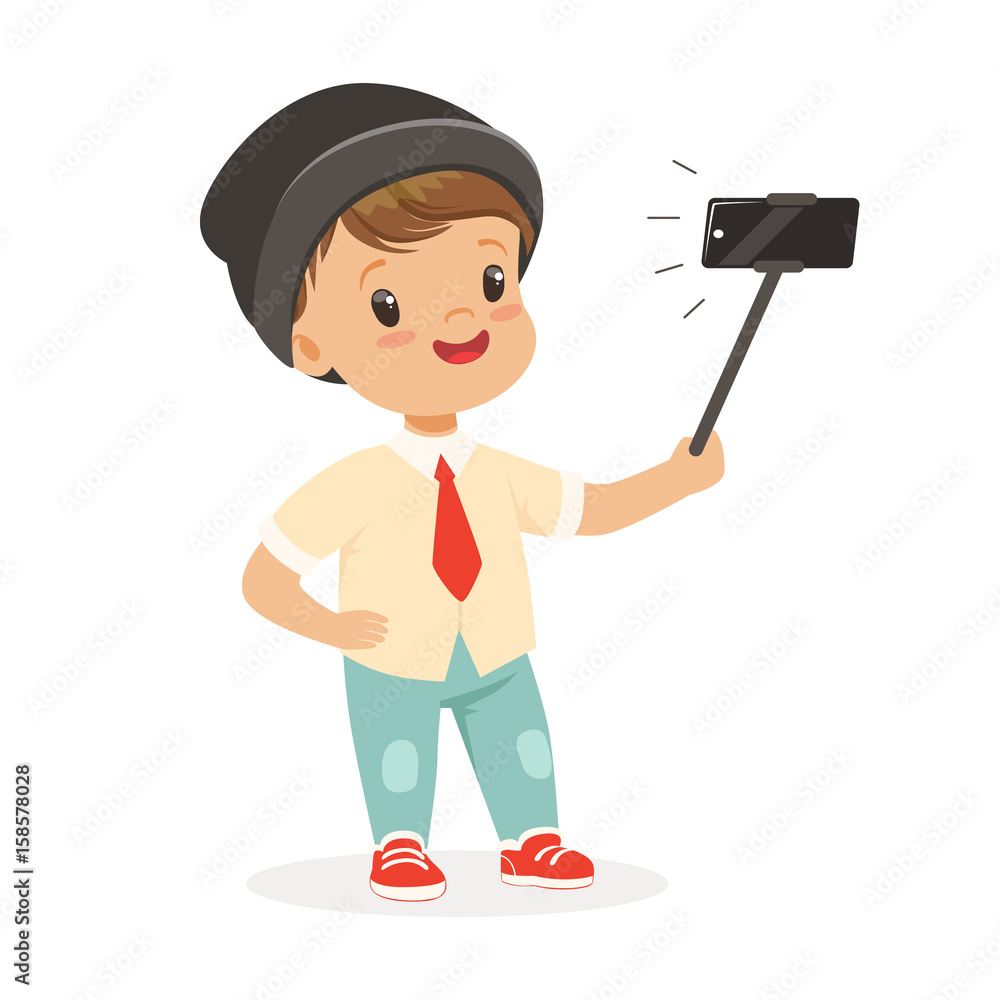 Cute little boy in fashionable clothes taking selfie with a selfie stick, colorful cartoon character vector Illustration Cute little boy in fashionable clothes taking selfie with a selfie stick, colorful cartoon character vector Illustration