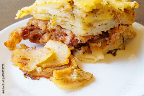 potato casserole with Turkey meat in a white plate. close up.