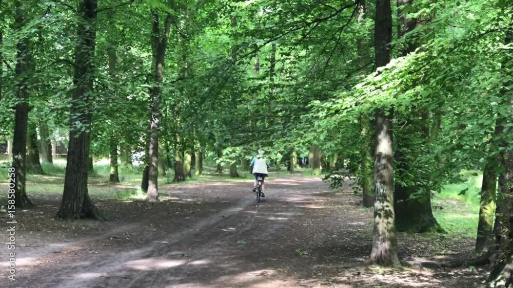 senior woman riding on her bike in the park senior woman riding on her bike in the park