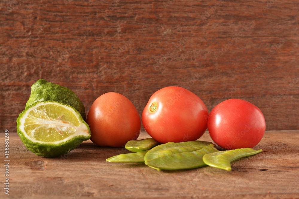 Tomatoes, bergamot and peas on old wooden floor for cooking. Tomatoes, bergamot and peas on old wooden floor for cooking.