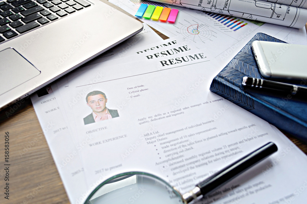 Resume (autobiography), pen, magnifier, laptop on your desktop. job search Resume (autobiography), pen, magnifier, laptop on your desktop. job search