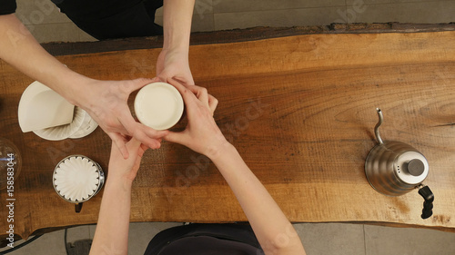 Happy waitress serving coffee at counter photo