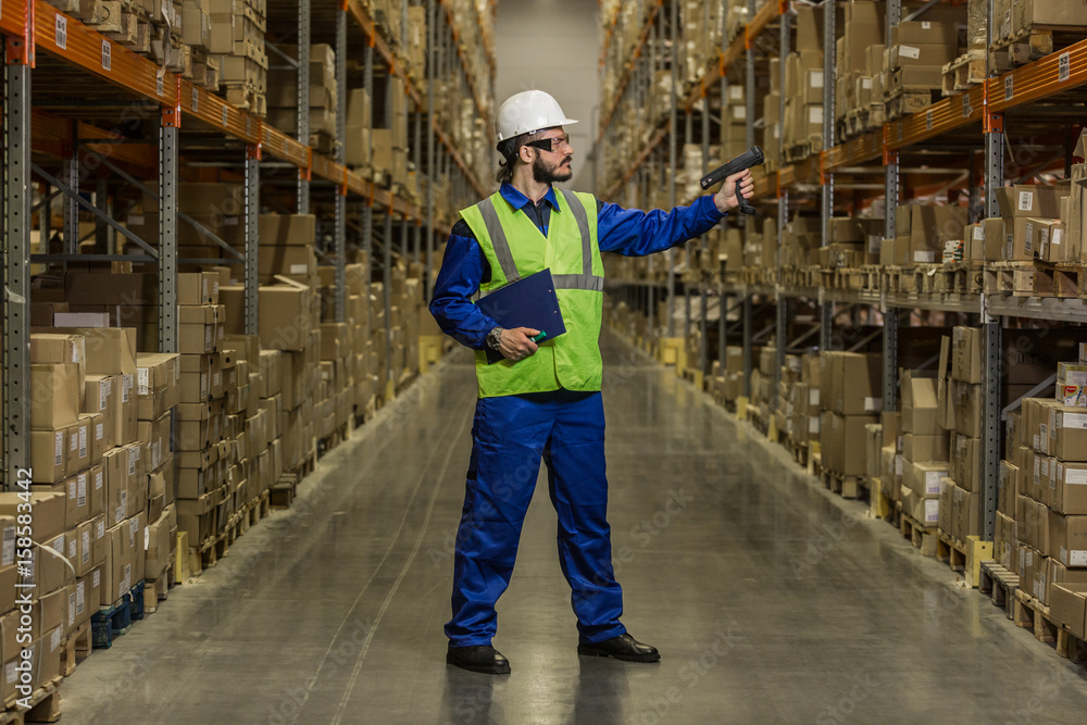 Man checking cargo on shelves with scanner