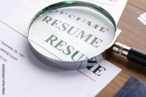 Photos Resume (autobiography), pen, magnifier, laptop on your desktop