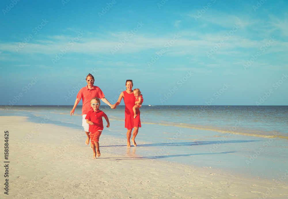 happy family with two kids run on beach happy family with two kids run on beach