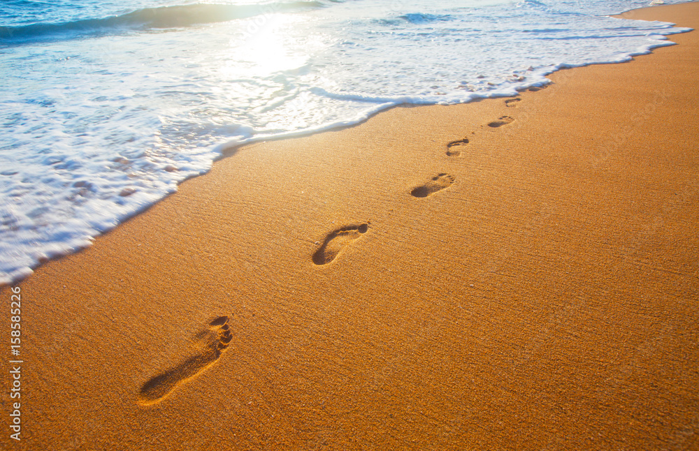 beach, wave and footprints at sunset time beach, wave and footprints at sunset time