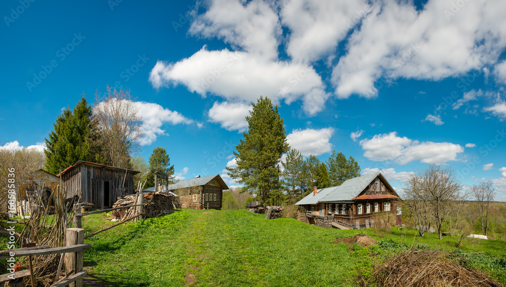Rural landscape.Clear blue sky over wooden houses in the Russian village.