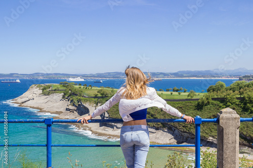 Young woman feels free vacation sea