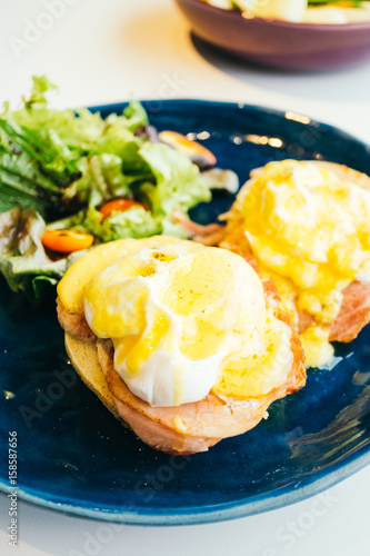 Eggs benedict with ham and sauce on top