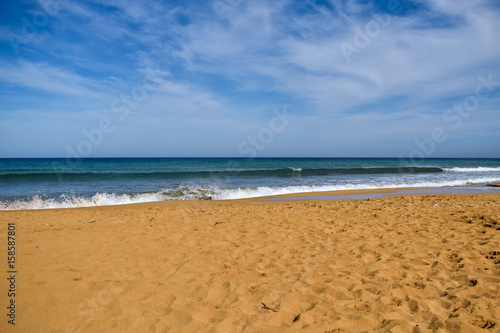 Splashing waves on sandy beach