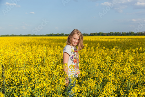 children in the field with the flowering yellow flowers of rape © Oleg