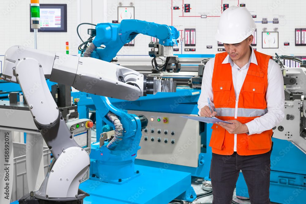 Engineer checking maintenance daily of automated robotic in production line, Industry 4.0 concept