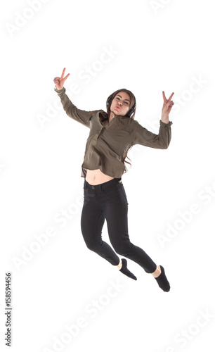 Girl with headphones which is dancing and jumping while listening to music. Lady with headset on white background