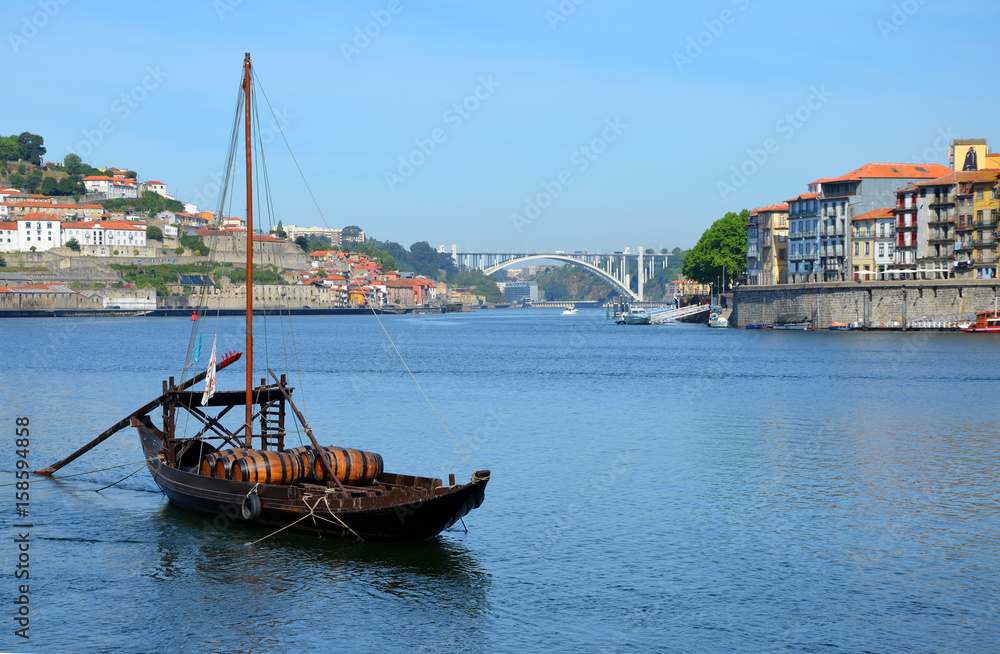 Porto, Portugal - 2nd May, 2017: Rabelo (traditional portuguese cargo boat) on Rio Douro and Ribeira (old town), a Unesco World Heritage Porto, Portugal - 2nd May, 2017: Rabelo (traditional portuguese cargo boat) on Rio Douro and Ribeira (old town), a Unesco World Heritage