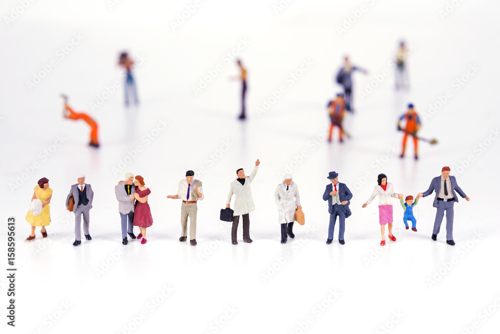 Line of diverse tiny miniature model people