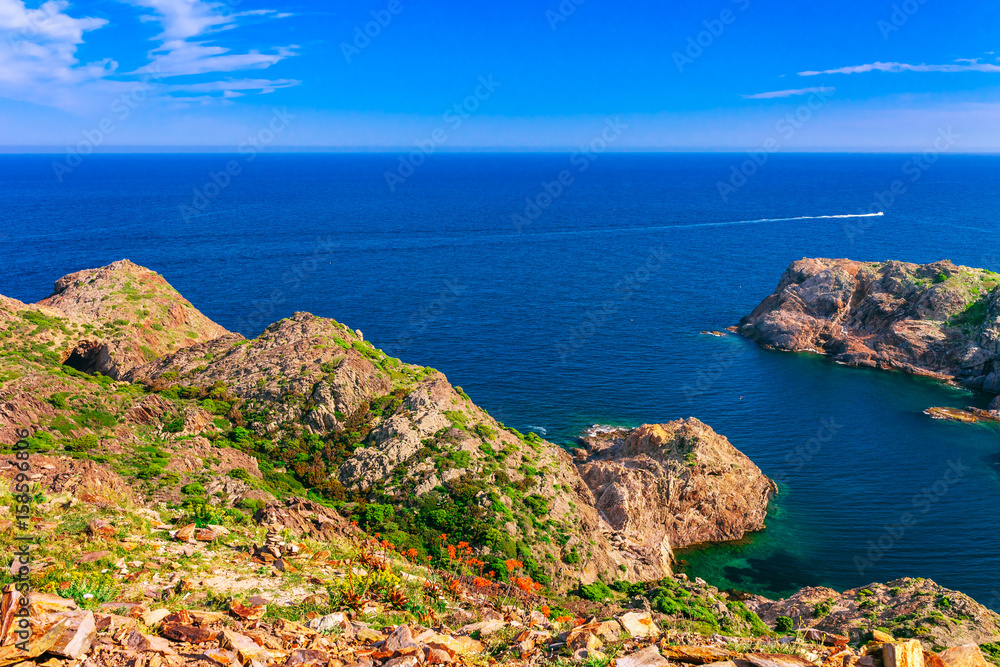 Sea landscape with Cap de Creus, natural park. Eastern point of Spain, Girona province, Catalonia. Famous tourist destination in Costa Brava. Sunny summer day with blue sky and clouds