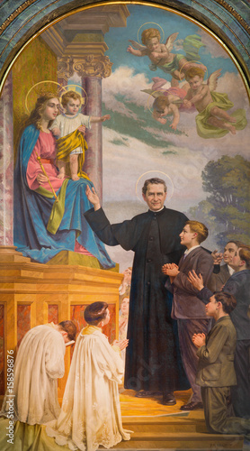 TURIN, ITALY - MARCH 15, 2017: The painting of Don Bosco and Mary Help of Christians in church Basilica Maria Ausiliatrice by Paolo Giovanni Crida (1941).