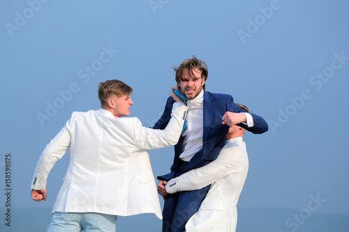 people fighting in nature on blue sky background