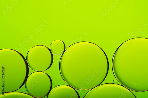 Oil drops in water, bubbles on green abstract background