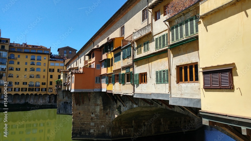 FLORENCE, ITALY - AUG 14, 2016: Arno river view with historic Ponte Vecchio bridge