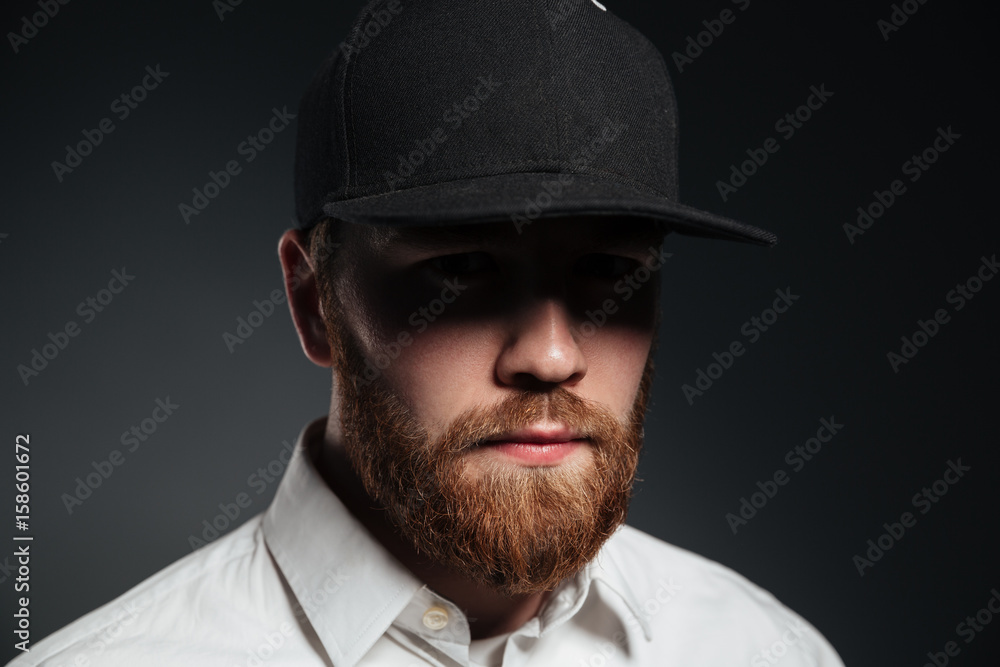 Handsome serious bearded young man wearing cap Handsome serious bearded young man wearing cap