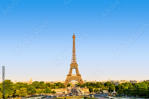 The Eiffel tower seen from the Trocadero esplanade in a warm light at sunset.