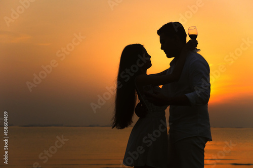 silhouette of a romantic couple on beauty sunset