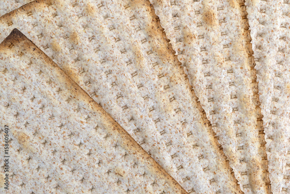 Whole wheat matzo crackers fanned out close view. Whole wheat matzo crackers fanned out close view.