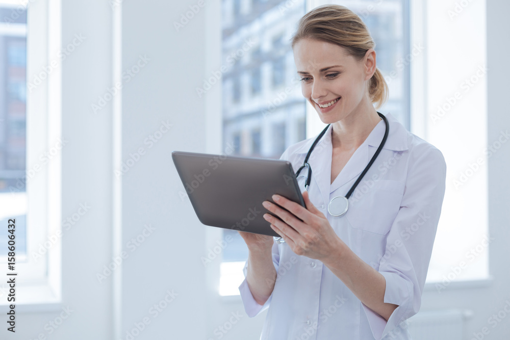 Involved doctor using electronic device in the hospital Involved doctor using electronic device in the hospital