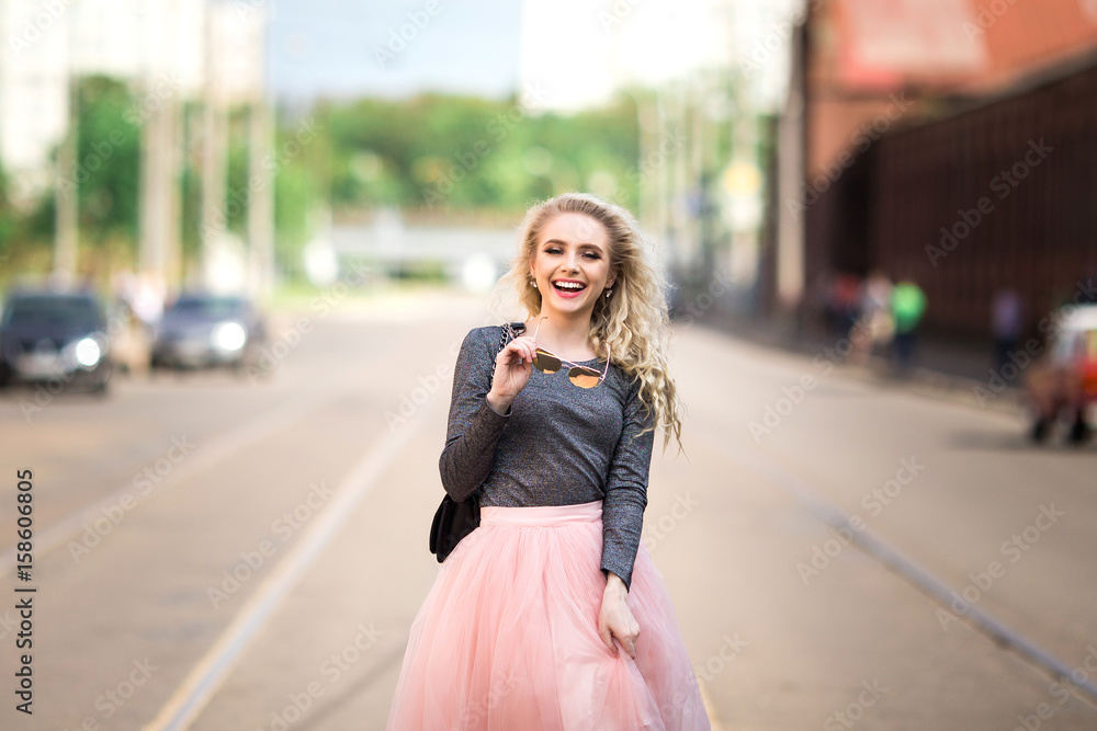 Fototapeta premium Very pretty girl walking down the street