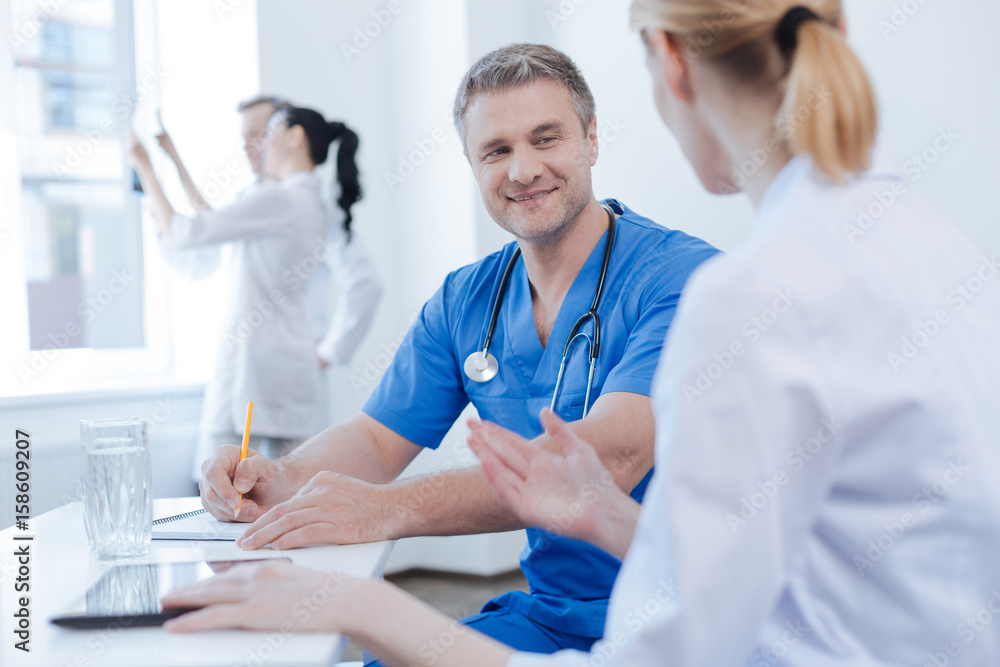 Fototapeta premium Energetic doctors enjoying discussion at the hospital